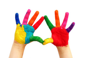 Child hands painted in colorful paints ready for hand prints